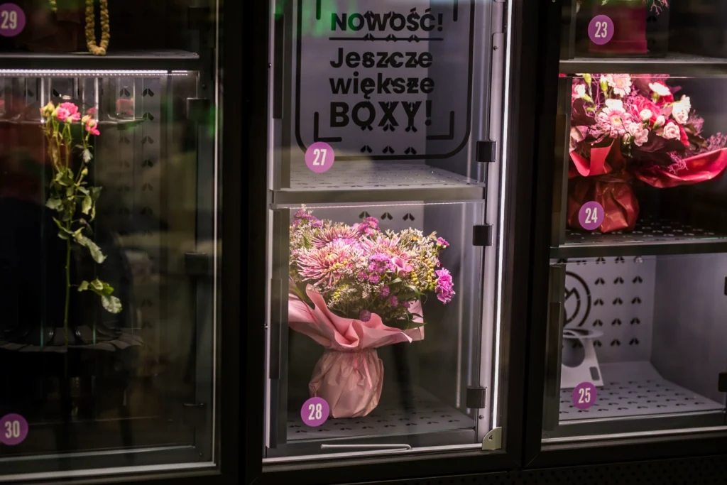 Fresh flower bouquets displayed inside a VendiFlor BouquetMat flower vending machine, showcasing large boxes and professional bouquet presentation.